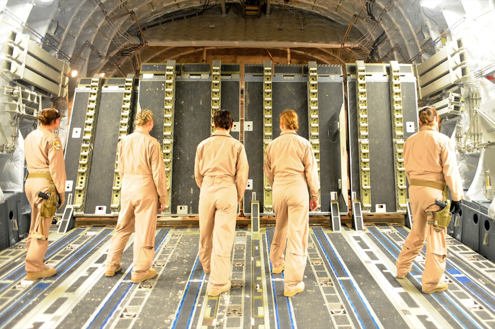 An all-female C-17 aircrew walking the cargo ramp in flight suits
