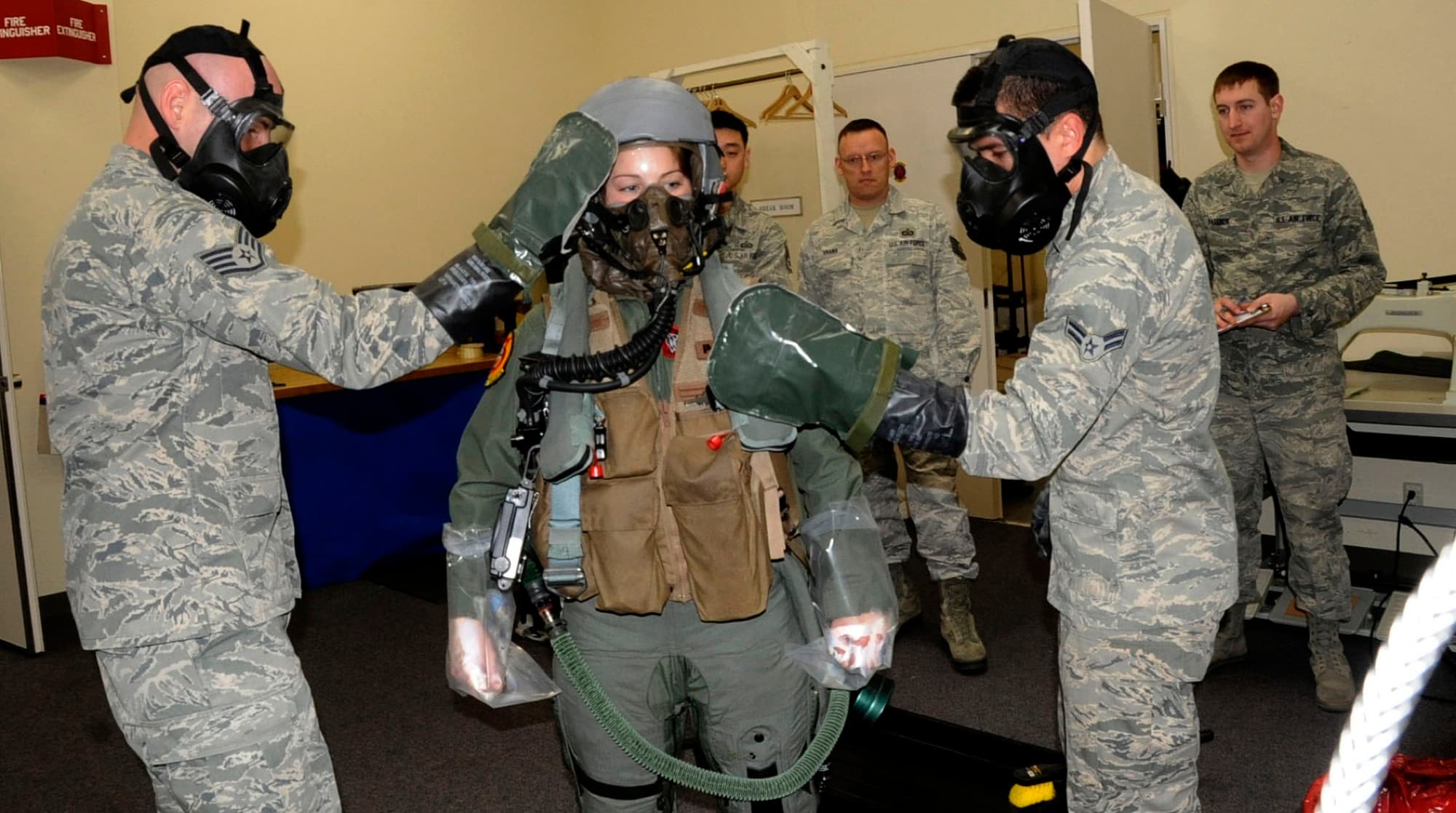 A female F-16 pilot having her helmet fitted before a flight