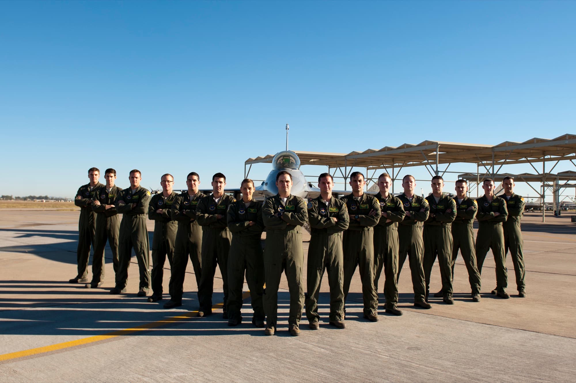 An F-16 fighter squadron in flight suits on the flightline at Luke Air Force Base
