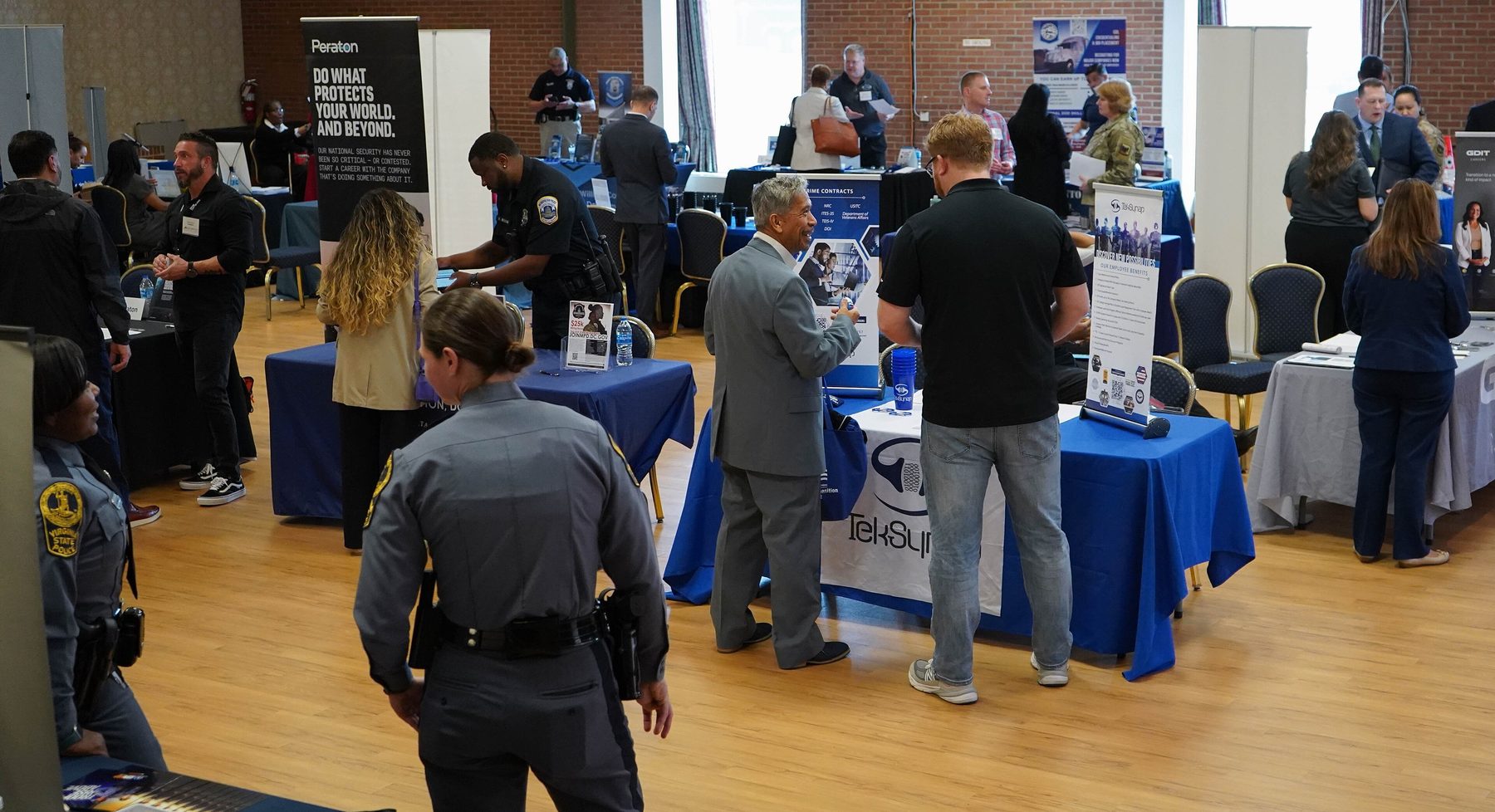 Job seekers speak with employers at a military community hiring event
